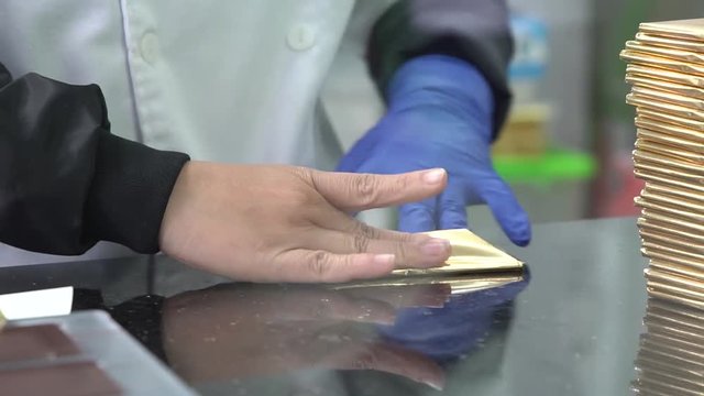 Packaging chocolate bars in wrappers in factory