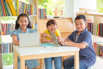 Three of asian student smiling in school library