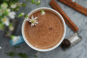 Blue Cup of Coffee Milk Latte Drink Cinnamon Sticks Wooden Background Rustic Camomile Flower Buquet Flat Lay