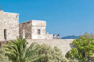 Unidentified people walk and explore in Bodrum Castle