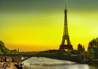 The Eiffel Tower and Cygnes bridge over river Seine at sunrise in Paris, France
