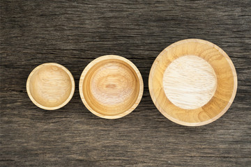 Top view of wooden three bowl on  wooden background