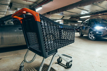 empty trolley at underground parking. shopping concept. copy space