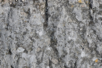 Close-up rough grungy cracked stone texture background. 