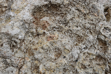 Close-up rough grungy cracked stone texture background. 