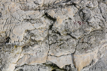 Close-up rough grungy cracked stone texture background. 