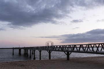 Fototapeta na wymiar Puente de madera en la playa de Mazagón, Huelva.