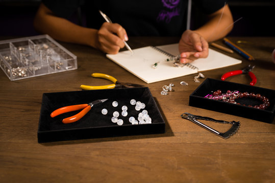 Jewelry Designer Works On A Hand Drawing Sketch