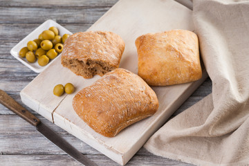 Homemade bread, knife and olives 