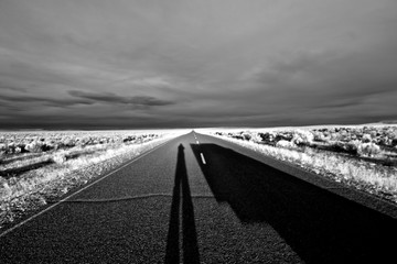 Unknown, long shadows on empty road appearing to be an “Alien Encounter”