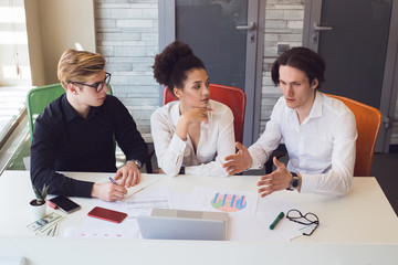 In work, do what you enjoy! Business team of smart creative people analyzing profit of a new...