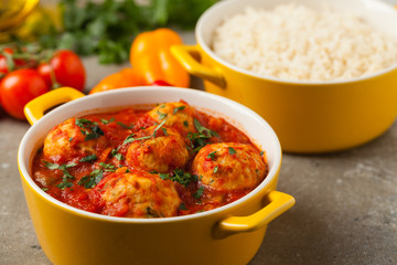 Chicken meatballs with tomato sauce. Served with rice.