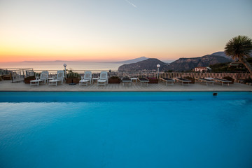 Fototapeta na wymiar Swimming pool on the Amalfi Coast with views of the Gulf of Naples and Vesuvius. Sorrento. Italy