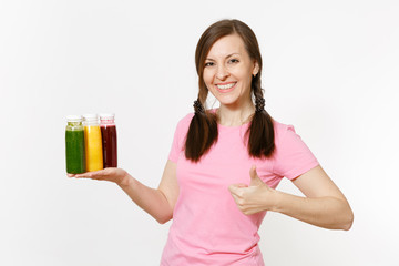 Fun woman holds row of green, red, yellow detox smoothies in bottles isolated on white background. Proper nutrition, vegetarian drink, healthy lifestyle, dieting concept. Copy space for advertisement.