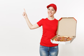 Delivery woman in red uniform isolated on white background. Pretty female in cap, t-shirt, jeans working as courier or dealer holding italian pizza in cardboard flatbox. Copy space for advertisement.