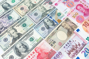 World’s various currencies from several different countries. Closeup assorted American dollar bills and Asian currencies such as Chinese yuan, Taiwan dollar, Japanese yen and Euro money.