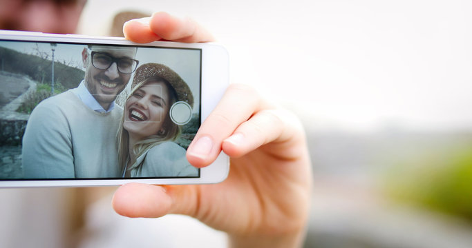 Couple in love taking selfies while traveling