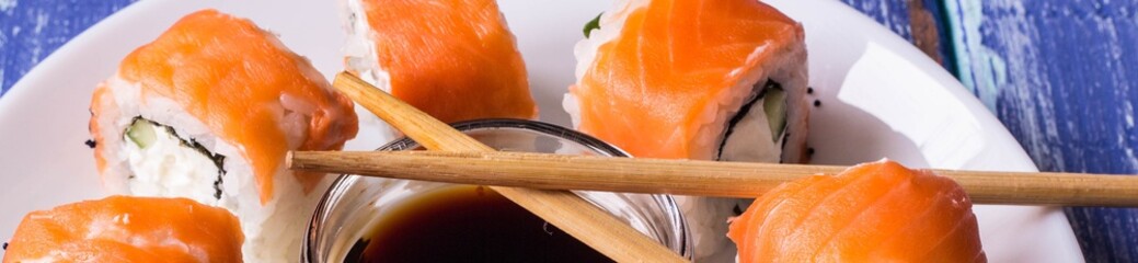 Banner of Philadelphia Maki Sushi made of Fresh Raw Salmon, Cream Cheese and Cucumber