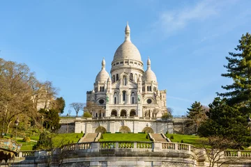 Fotobehang Parijs The basilica of the Sacred Heart of Paris under a blue sky in springtime seen from the bottom of the Louise Michel park, with the terrace and stairways on the foreground.  © olrat