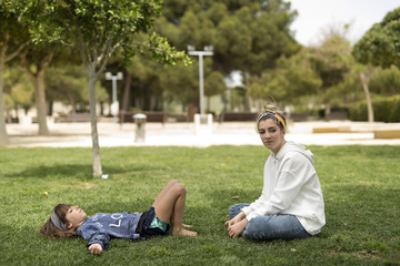 Fototapeta premium Two sisters looking at each other smiling.