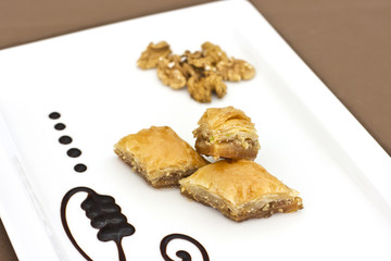 Traditional oriental dessert - baklava with pistachios and walnuts. Isolated