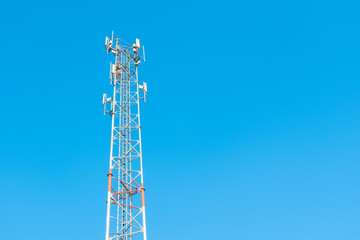 Antenna tower of telecommunication and signal repeater of mobile communication with blue sky background.