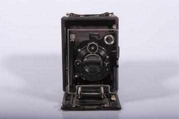 antique Vintage medium format camera with a sliding fur isolated on a light background