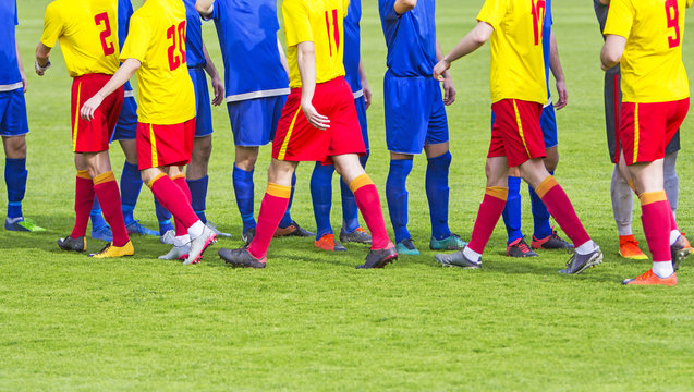 Two soccer team handshake on field before the football game - Powered by Adobe