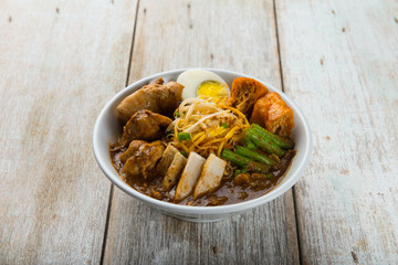 malaysia curry noodle with wood background