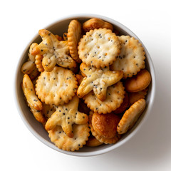 Baked party poppy seed crackers in white ceramic dish isolated on white from above