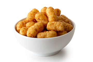 Extruded peanut flips in white ceramic dish isolated on white.