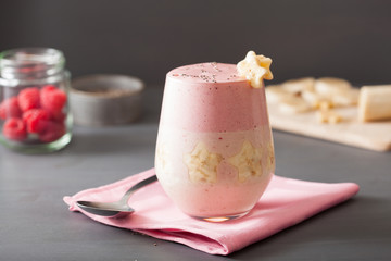 healthy layered raspberry banana smoothie in glass