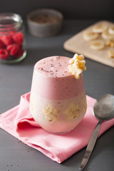 healthy layered raspberry banana smoothie in glass