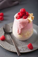 healthy layered raspberry banana smoothie in glass