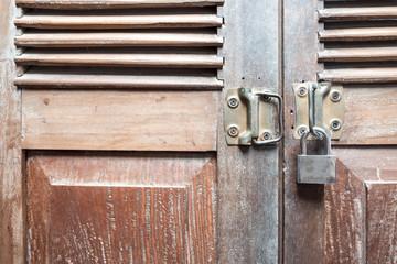 Vintage wooden door texture background with old steel lock is locked the door