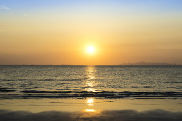 Beautiful sunset over sea and tropical beach in summer time. Natural background of sunset dawn and sunrise with bright dramatic scenic sky.
