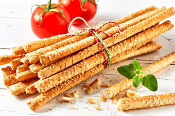 Bunch of grissini breadsticks with tomatoes