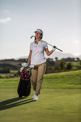 Woman on field with golf driver