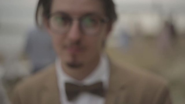 Man holds his hands mouth after he closes camera