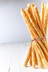 Tied bundle of grissini breadsticks with a twist