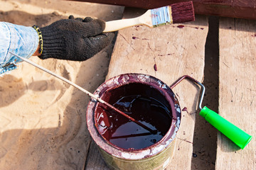 bank with paint on a wooden background