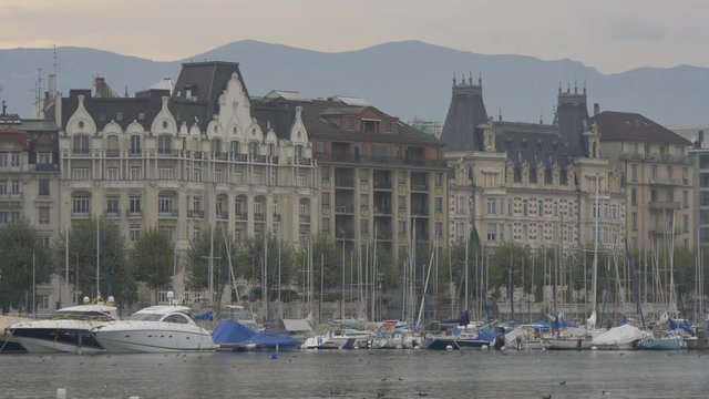 Boats with masts anchored on the shore, Geneva