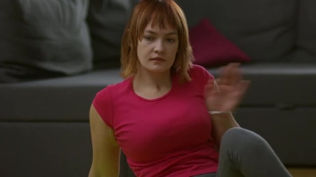Tilt up of paraplegic woman practicing yoga and stretching