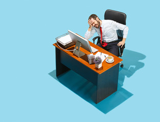 Shot from above of a stylish business man working on a laptop.