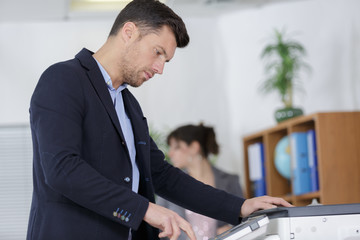 businessman analyzing investment charts with printer