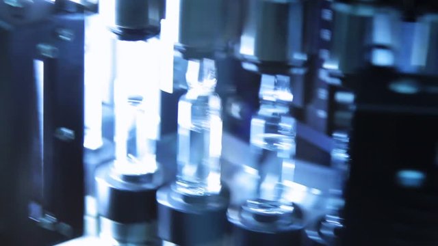 Pharmaceutical quality control of medical vials. Ultraviolet light in control technology of medical ampoules. Quality control of glass ampules at pharmaceutical plant.