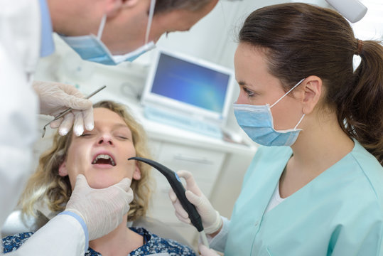 patient dentist and assistant in office of a dental clinic