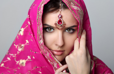 Beautiful fashion Indian woman portrait with oriental accessories earrings