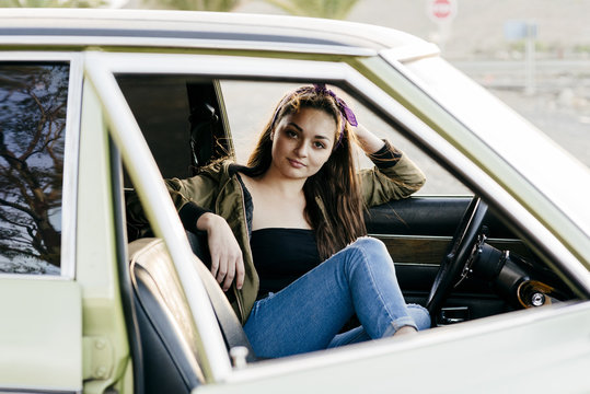 Woman sitting in vintage car