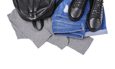 Sneakers backpack jeans and a light sweater.